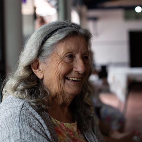 smiling woman in gray cardigan