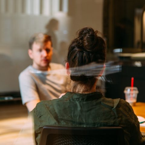 person sitting in a chair in front of a man