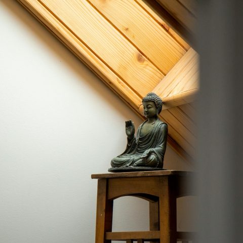 gray ceramic figurine on brown wooden table
